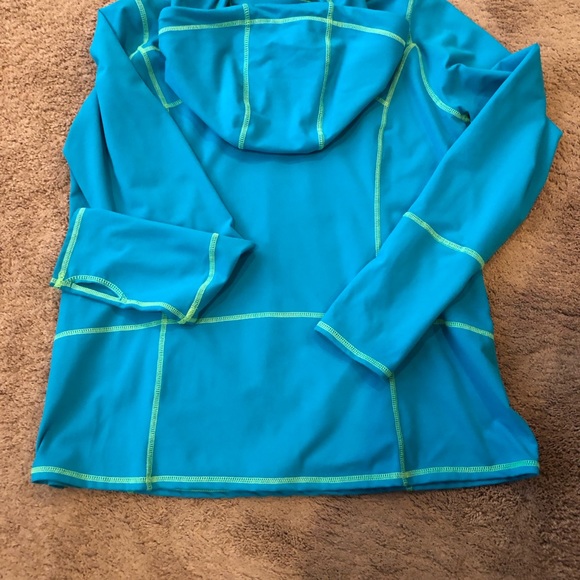 Kirkland Blue long Sleeve Front Zip Top with Hood. 85% Polyester, 15% Spandex. - Picture 6 of 6